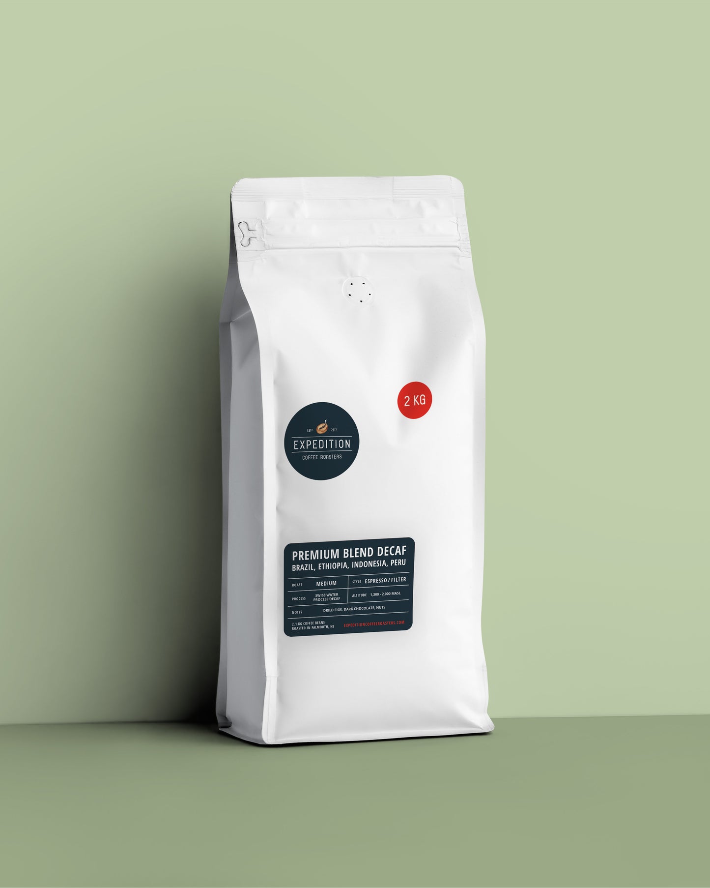 White decaf coffee bag with a label on a green background
