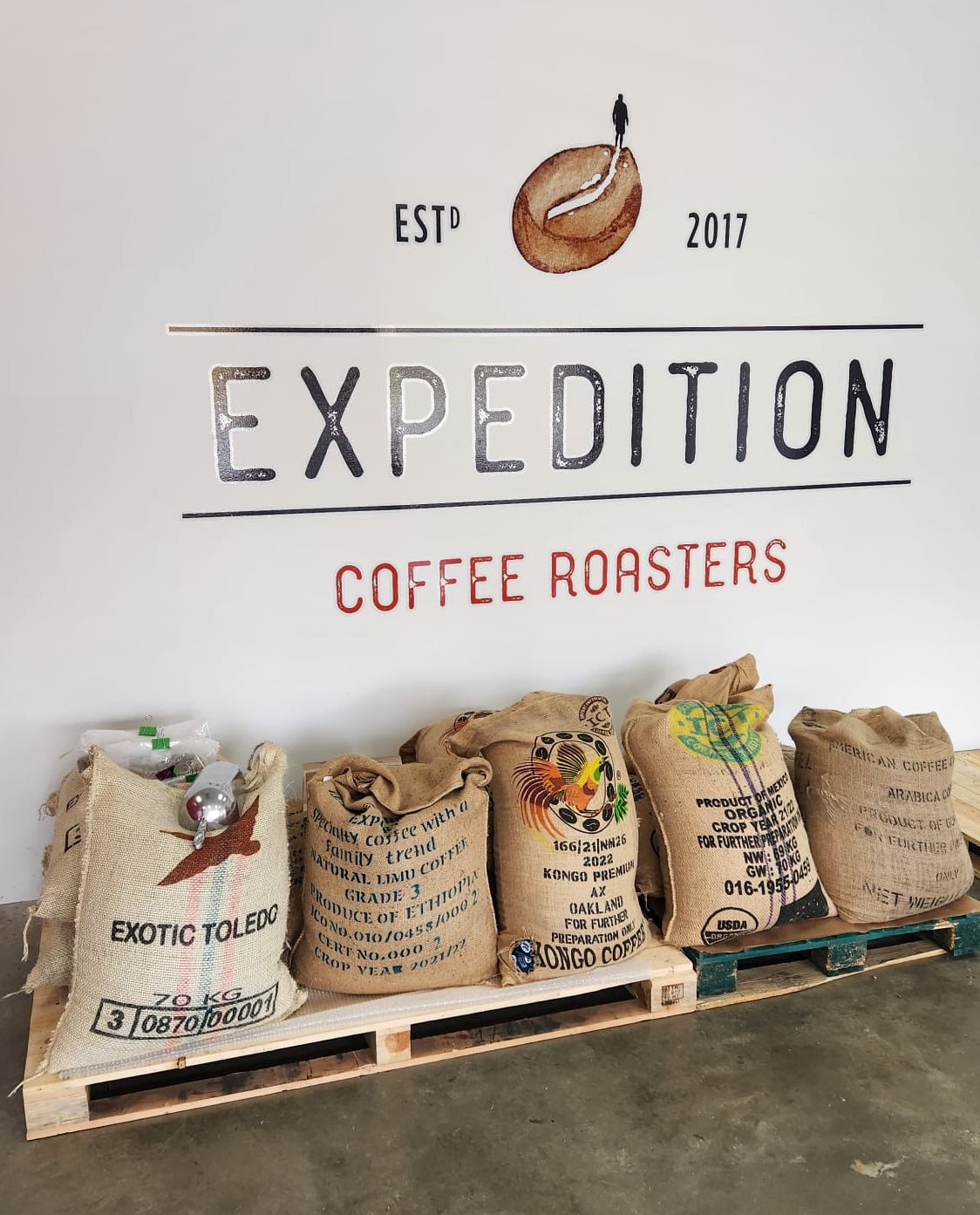Coffee roaster Nova Scotia burlap bags of raw coffee beans at Expedition Coffee Roasters roastery.