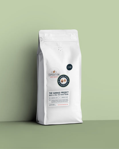 White 2kg coffee bag with a label on a green background, medium-light roast brazil and png coffee beans